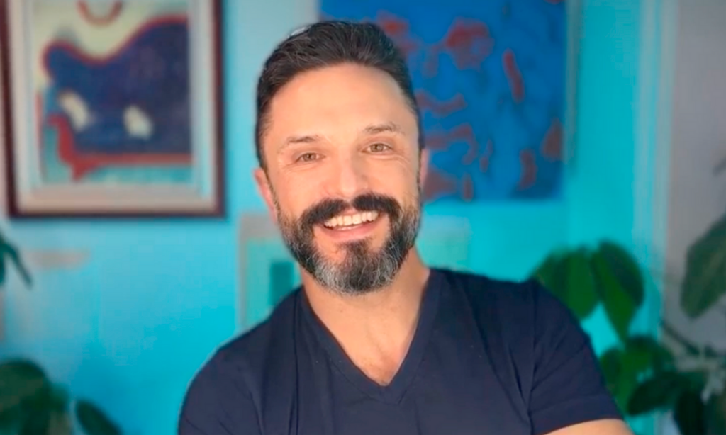 marc scheff smiling with a blue background